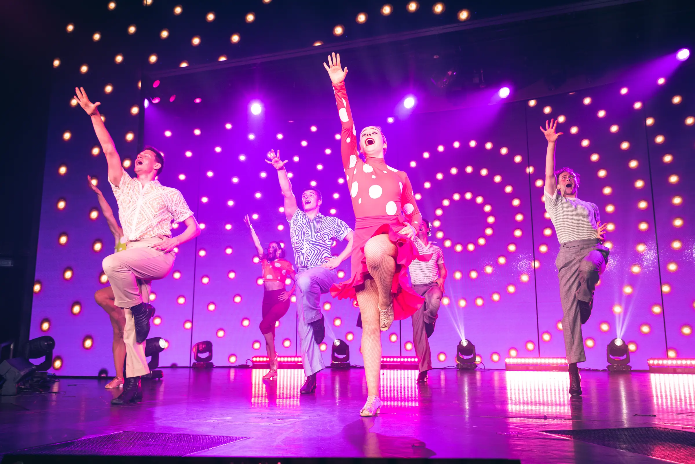 Dynamic Broadway-style dance performance on the Holland America World Stage featuring talented artists in vibrant costumes. Enjoy award-winning entertainment from Broadway-style shows to live music. Experience dynamic dance performances and pop-up concerts every night.