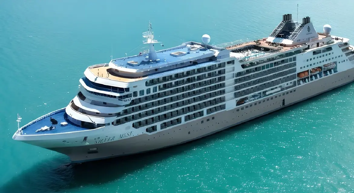 A sleek white and silver cruise ship sailing on bright, transparent emerald water under a sunny tropical sky. Experience Silversea 2026. Enjoy all-suite luxury, butler service, and all-inclusive value on Emerald Seas to the world’s most unique ports.