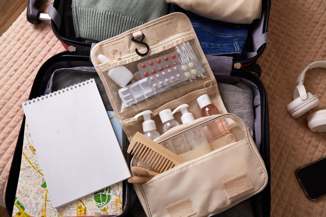 Open suitcase with travel essentials for packing.