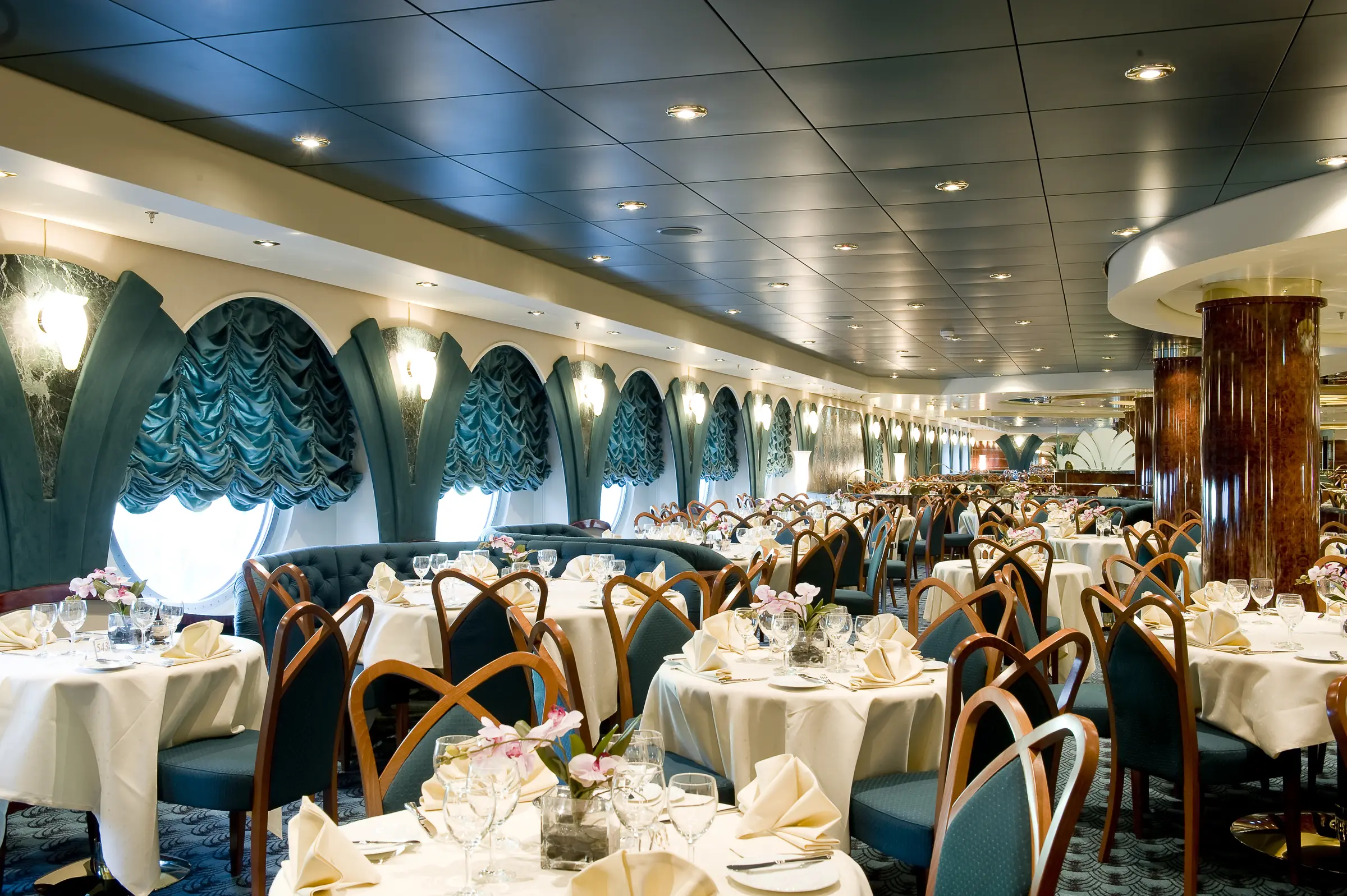 Savor gourmet cuisine in a sophisticated MSC restaurant featuring stunning blue-themed interiors and a tranquil nautical atmosphere.