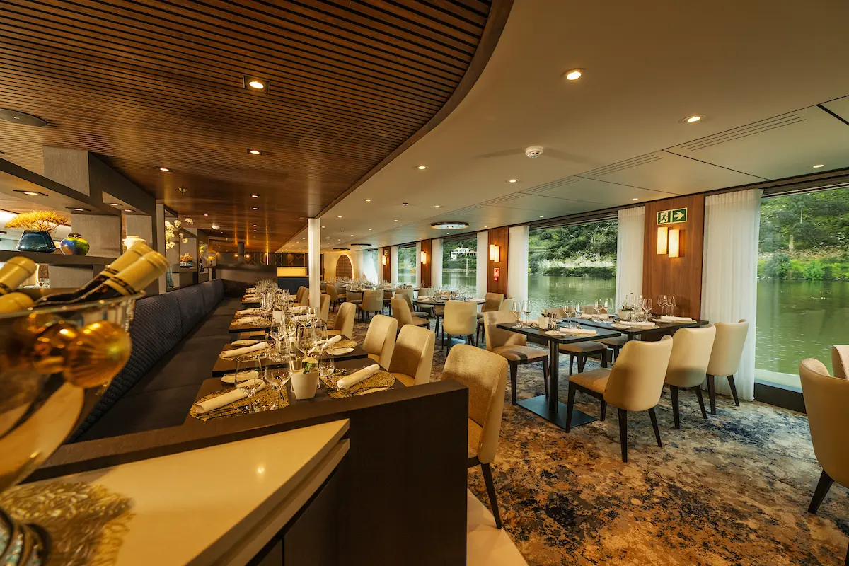 Experience fine dining in the Avalon Waterways Bistro, where wall-to-wall windows offer immersive views of Europe's river scenery. 