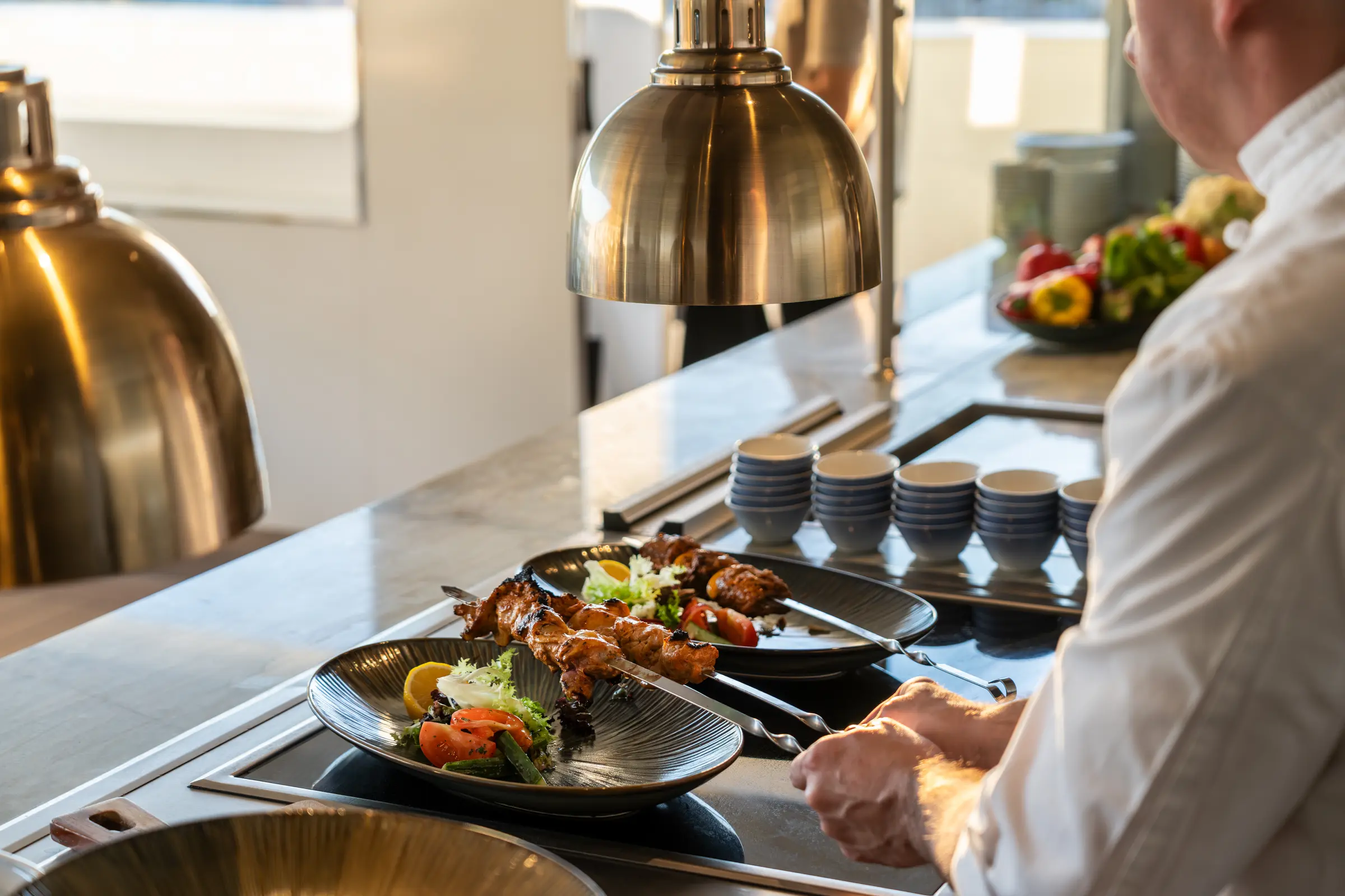 Watch master chefs craft Michelin-inspired cuisine at the intimate dining bar, where bespoke flavors and culinary artistry meet in 2026.