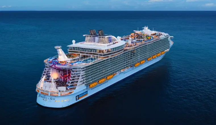 A vibrant cover of a Royal Caribbean ship at sunset, highlighting the 2026 sales event.