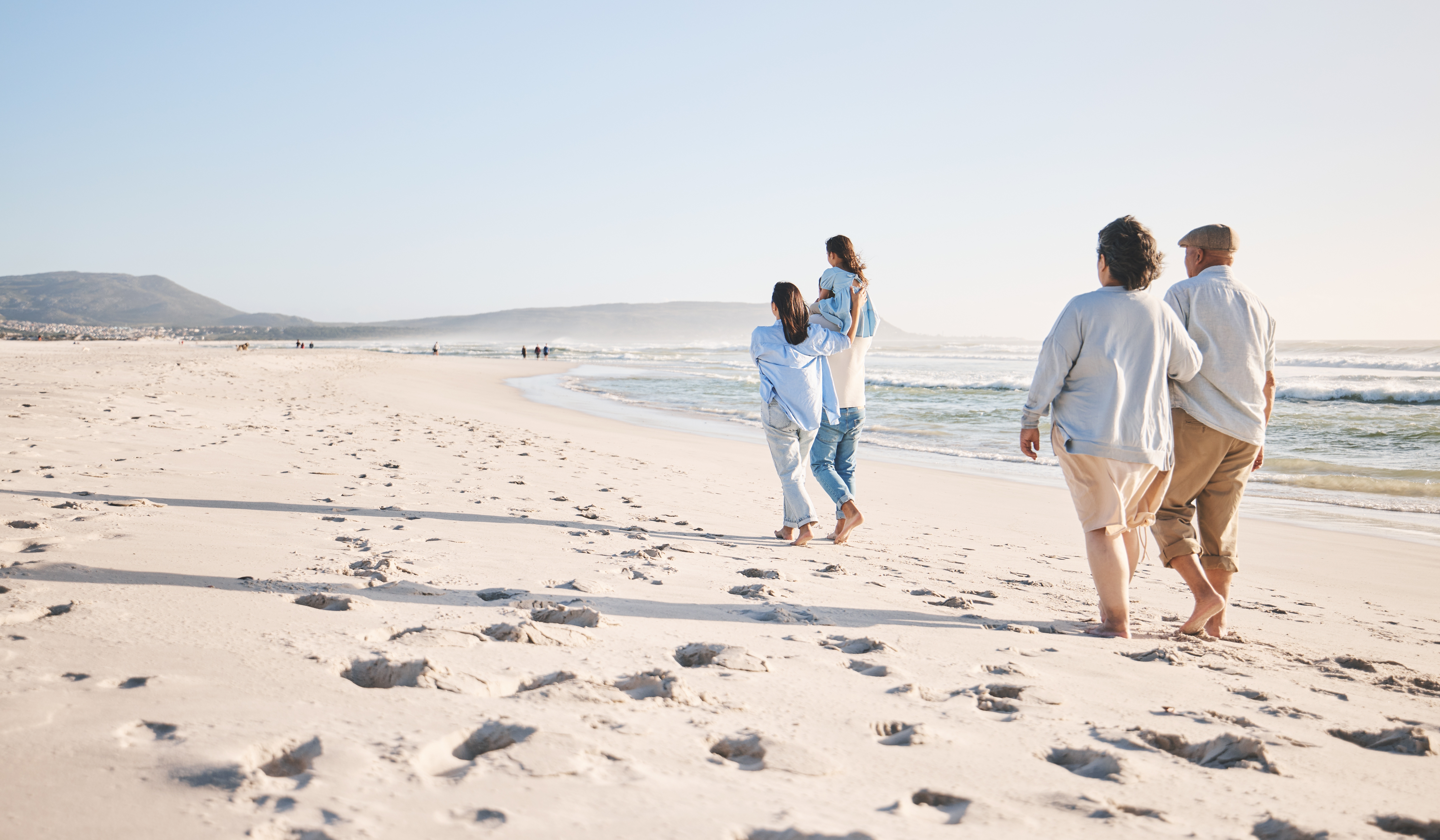 Families walking along the beach during a cruise vacation.