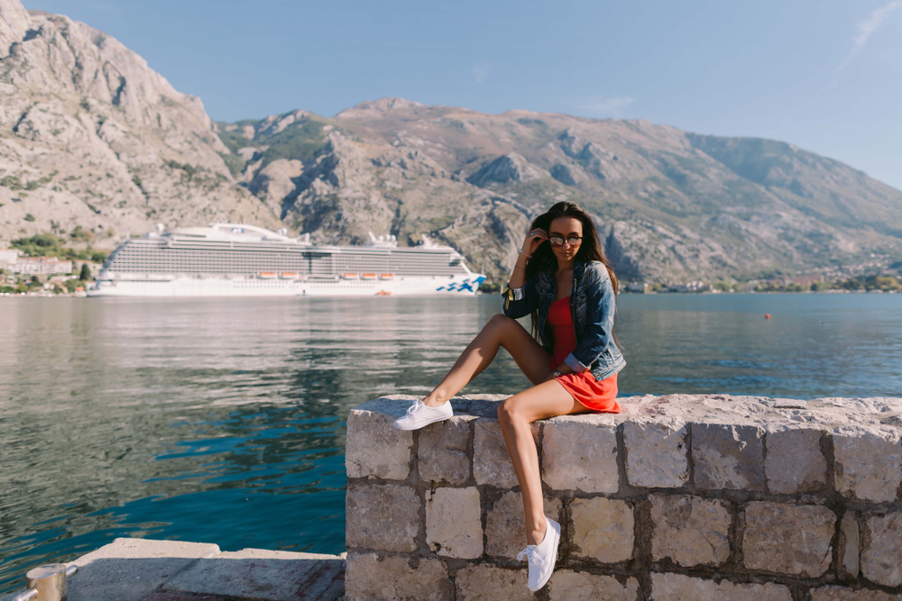 Woman sitting on a low stone wall