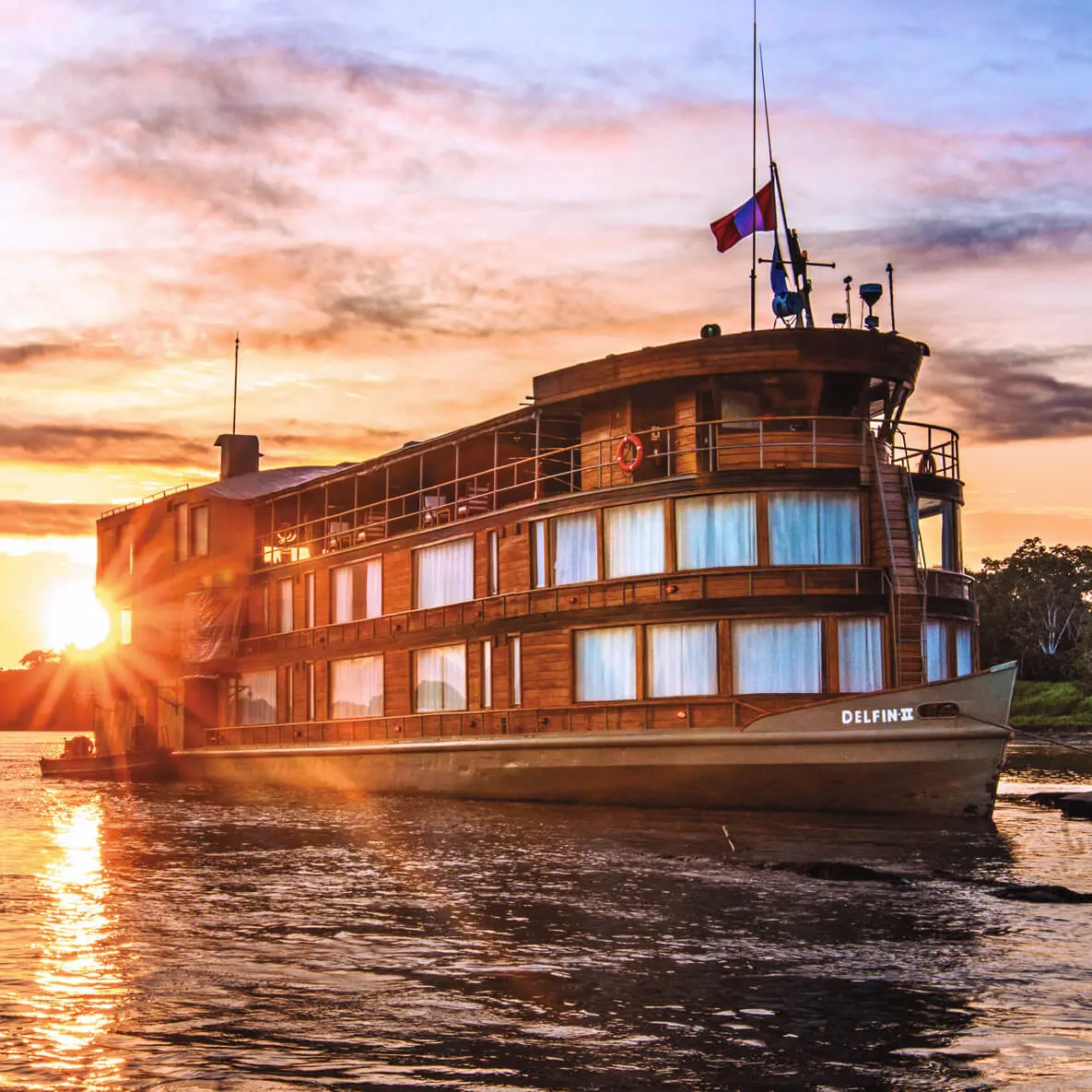 Delfin II is a stately riverboat, recently built for the express purpose of exploring deep into the Peruvian Amazon at the headwaters of this mighty river&mdash;and doing so in modern tropical style. Delfin II comfortably accommodates 28 guests in 10 suites and four master suites. At 120 feet, she is perfectly sized to sail along the upper Amazon River. Her top deck offers an open-air observation lounge with a bar and comfy chairs ideal for relaxing at the day&rsquo;s end and watching the jungle scenery glide past. The top deck&rsquo;s air-conditioned presentation room at the stern with large picture windows on three sides is where photo talks and daily Recaps are held. With board games, computer stations, and comfortable seating with a contemporary flair, this room is also perfect for relaxing.