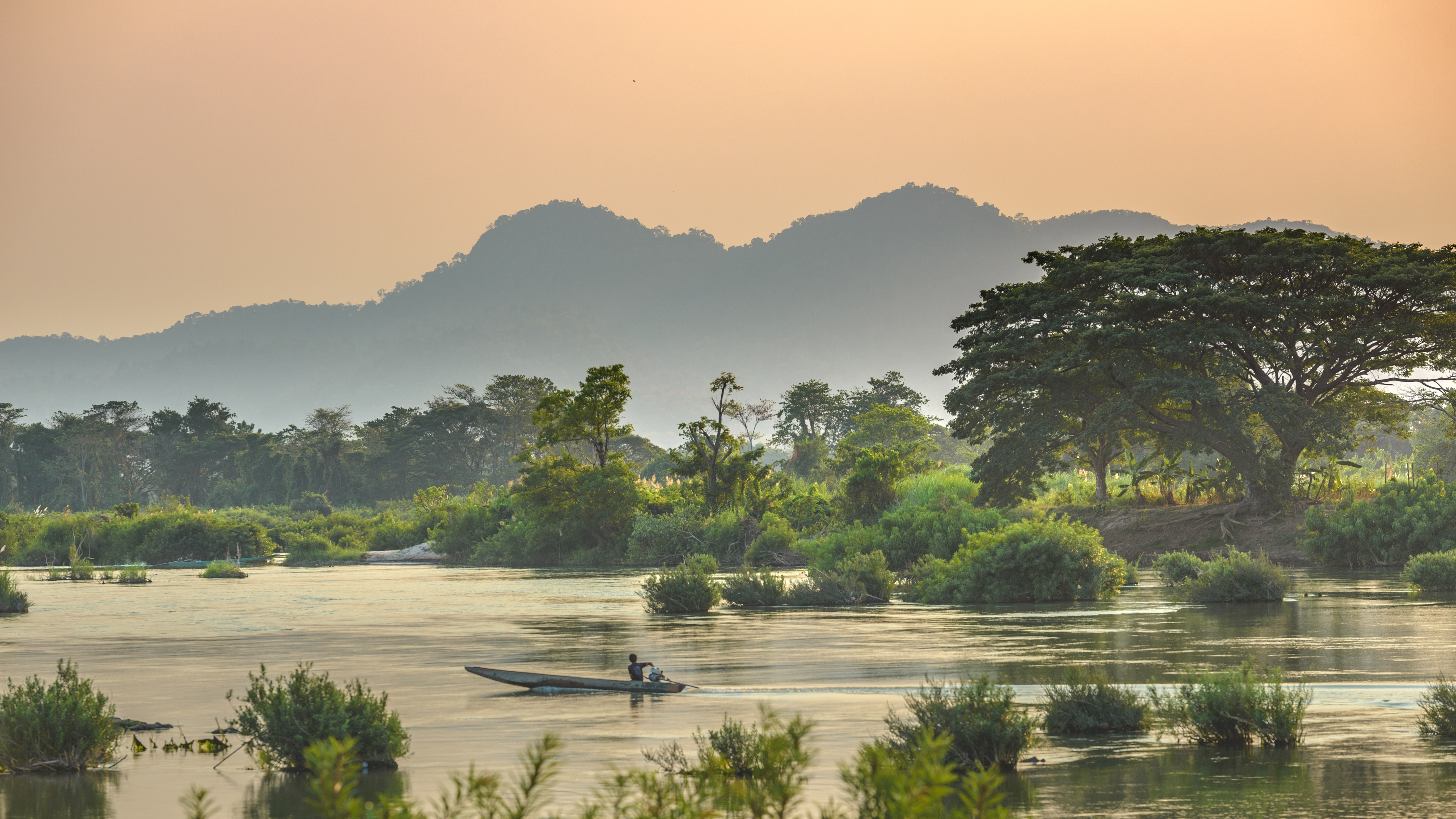 Mekong River, sunrise dramatic sky, mist fog on water.