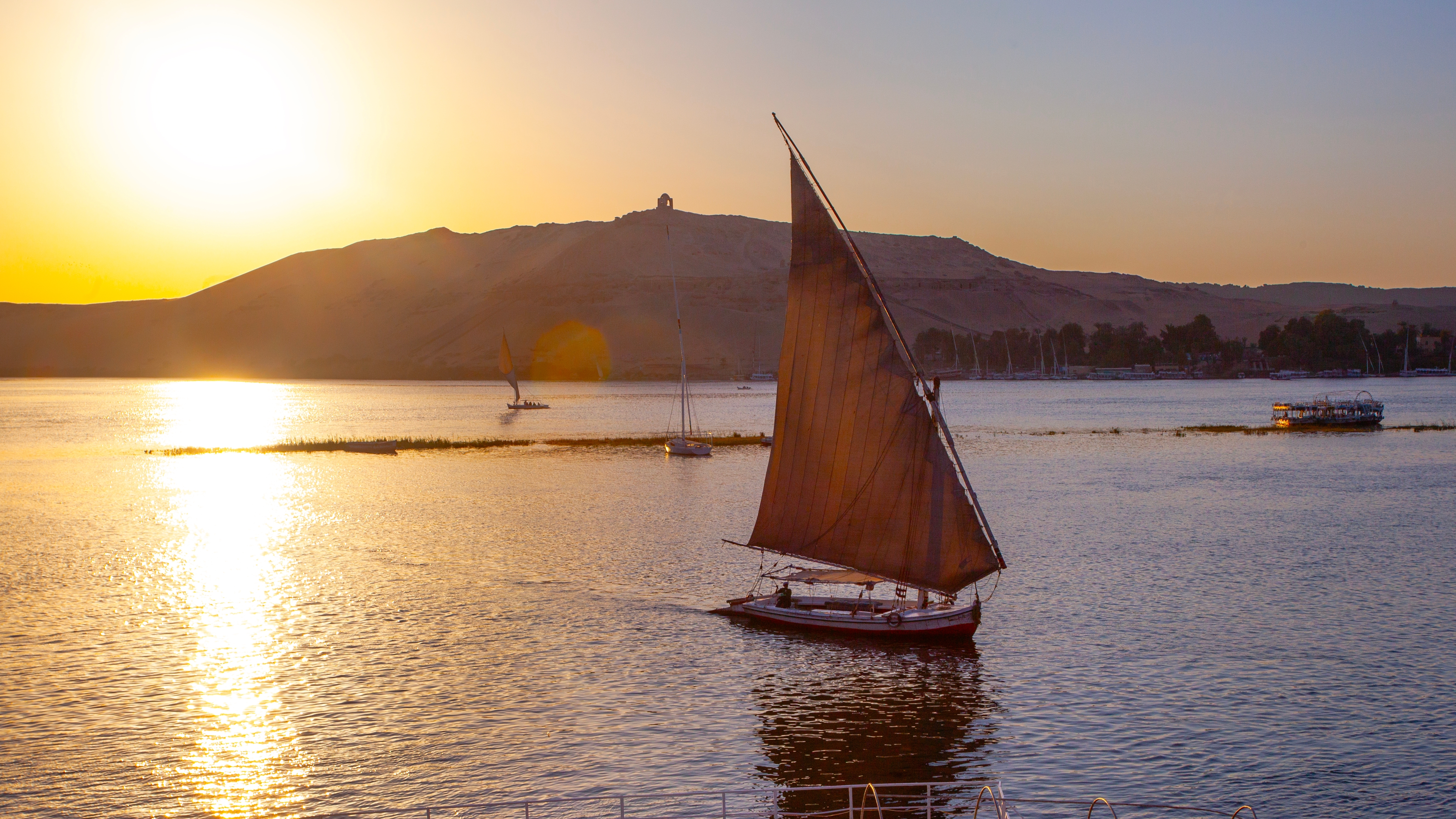 Sailing boat on the Nile river at sunset time.