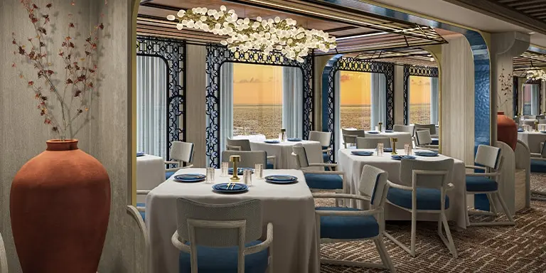 Savor gourmet cuisine in a sophisticated setting, featuring pristine white linens and fresh floral arrangements.
