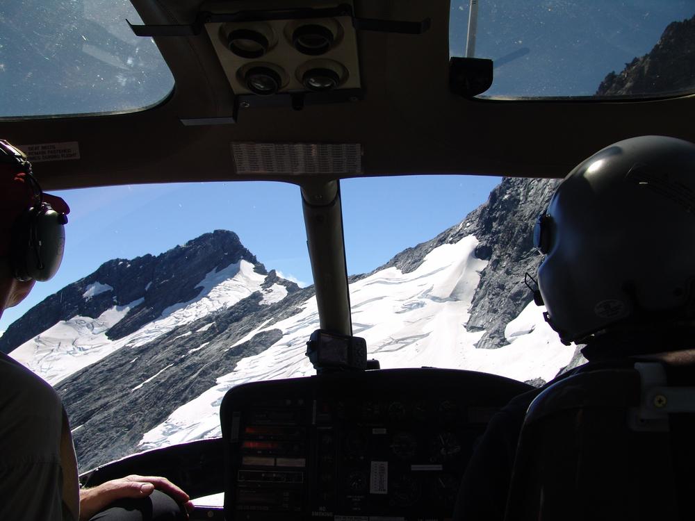 A pilots' view during the flight over mountains from the helicopter cabin
