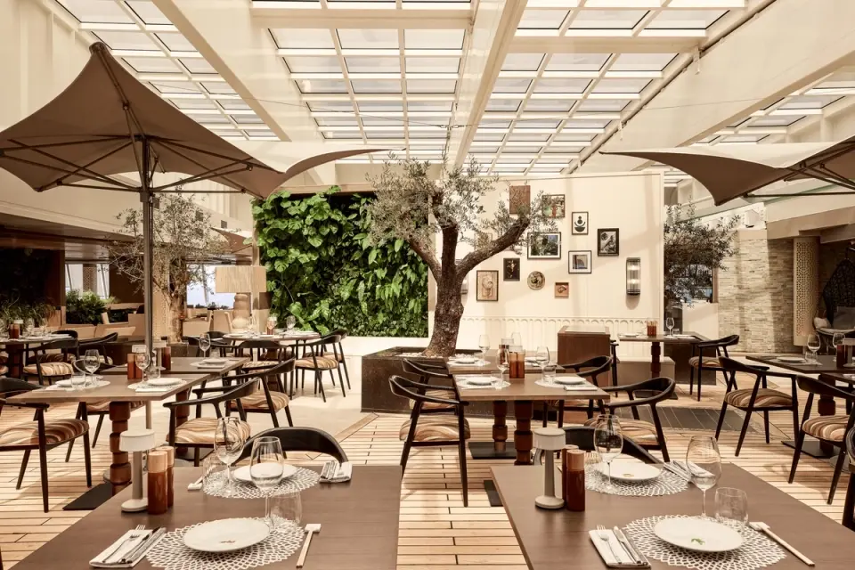 Enjoy refined al fresco dining in a sophisticated garden-inspired setting, where fresh cuisine and luxury ambiance come together at sea.