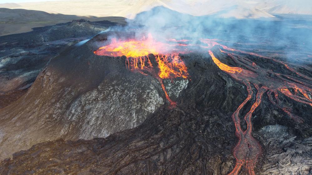 A landscape of lightening erupting from Mauna Loa Volcano in Hawaii with smoke and a hazy sky