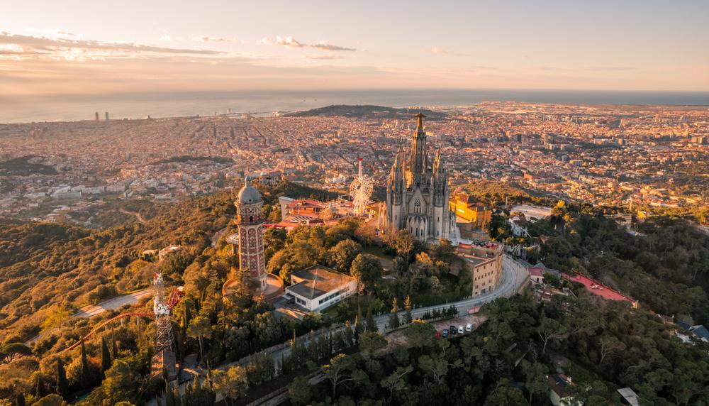 Aerial view of Barcelona skyline with Sagrat Cor temple during sunrise, Catalonia, Spain